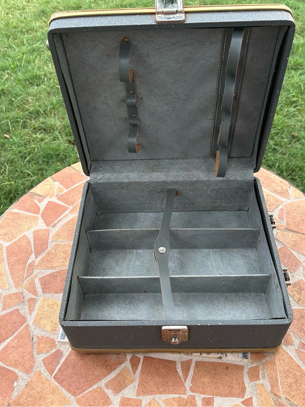 Vintage travel case with durable gray vinyl exterior and interior compartments